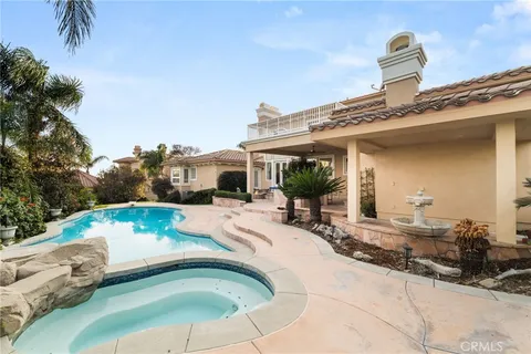 an aerial view of residential houses with outdoor space and parking