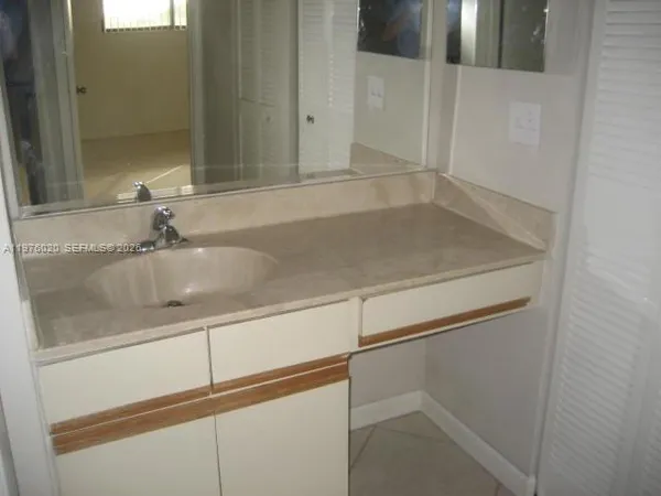 a close view of a sink and a mirror in a bathroom