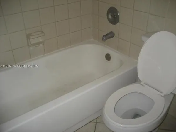 a bathroom with a toilet and a bathtub