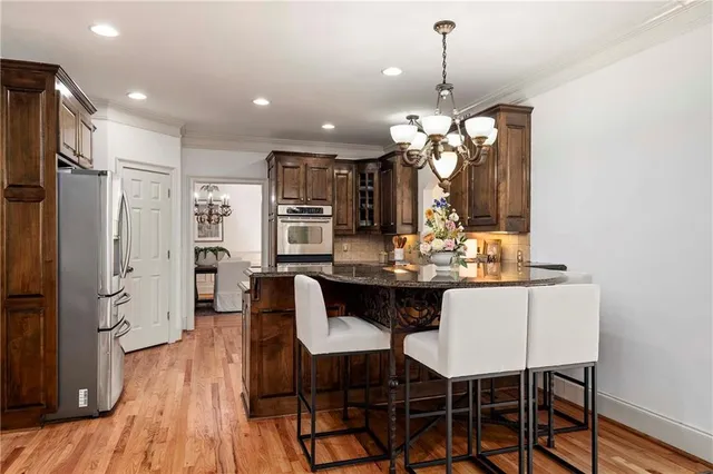 a view of a dining room with furniture wooden floor and chandelier