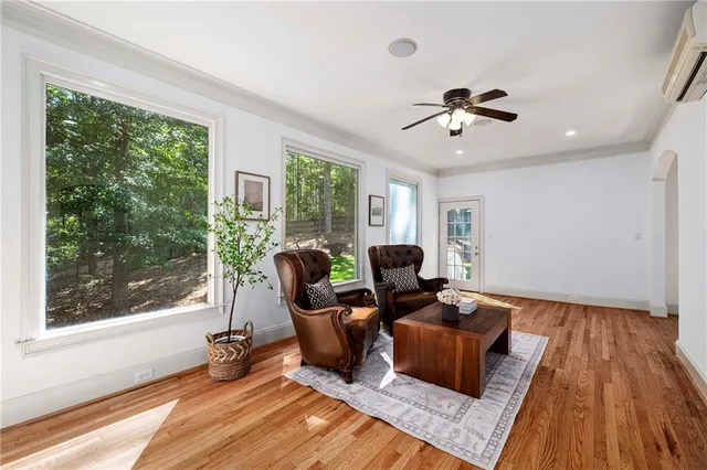 a living room with furniture a table and wooden floor