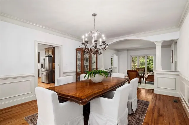 a living room with furniture wooden floor and a large window