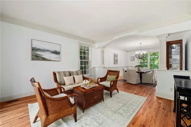 a living room with furniture a air conditioner and a window