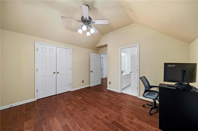 a view of a workspace with furniture and a window