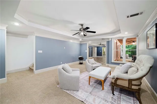 a view of room with windows and ceiling fan