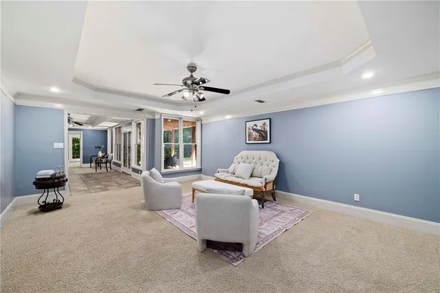 a view of a patio with table and chairs and floor to ceiling window
