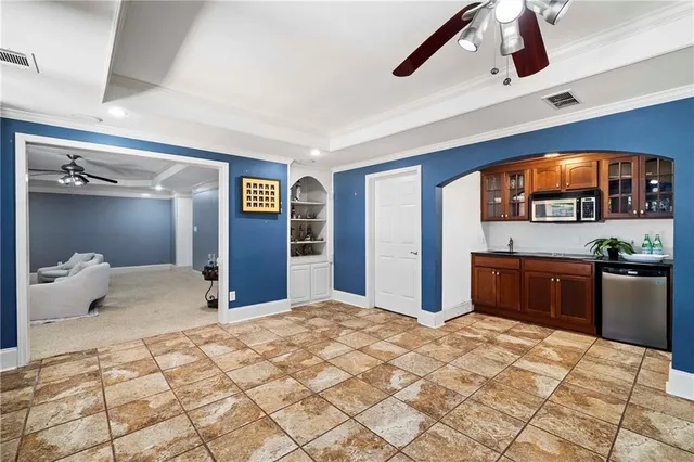 a view of a patio with chairs and floor to ceiling window