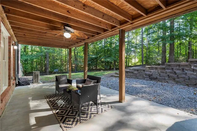 a view of a house with swimming pool and sitting area