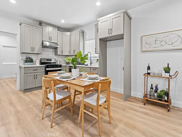 a kitchen with granite countertop white cabinets and stainless steel appliances