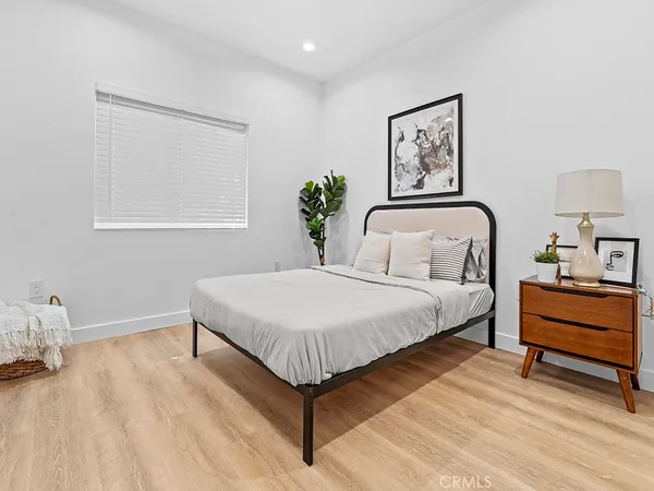 a bedroom with a bed and a painting on the wall