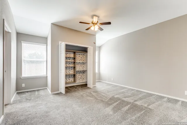 a view of a livingroom with a ceiling fan and window