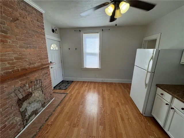 a view of a livingroom with wooden floor and staircase