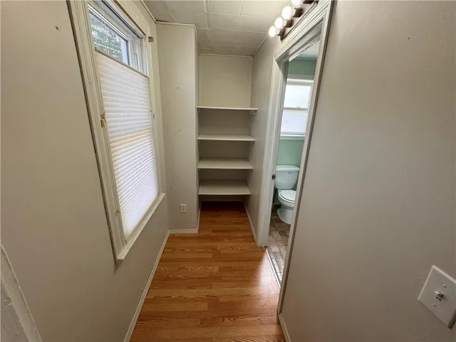 a view of a hallway with wooden floor and entryway