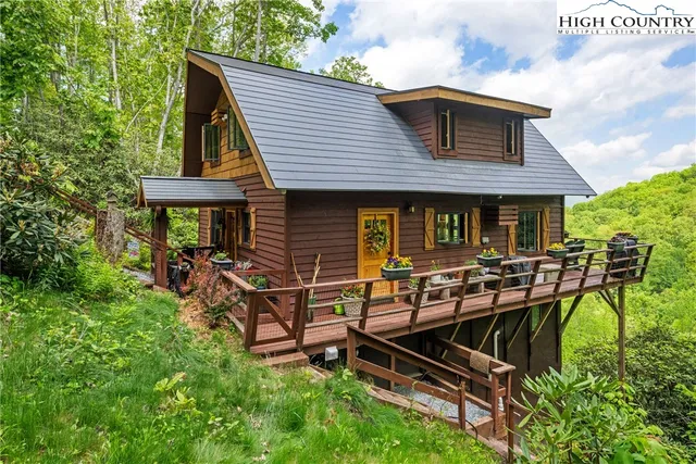 a view of a house with backyard sitting area and garden