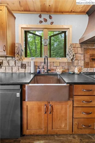 a kitchen with a sink and large window