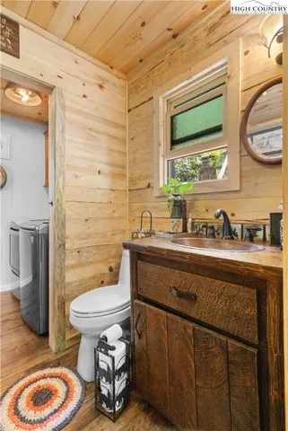 a bathroom with a granite countertop toilet sink and mirror