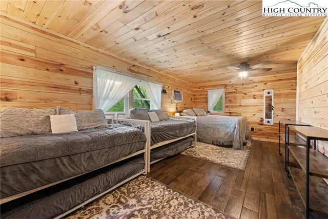 a bedroom with double bed and a wooden floor