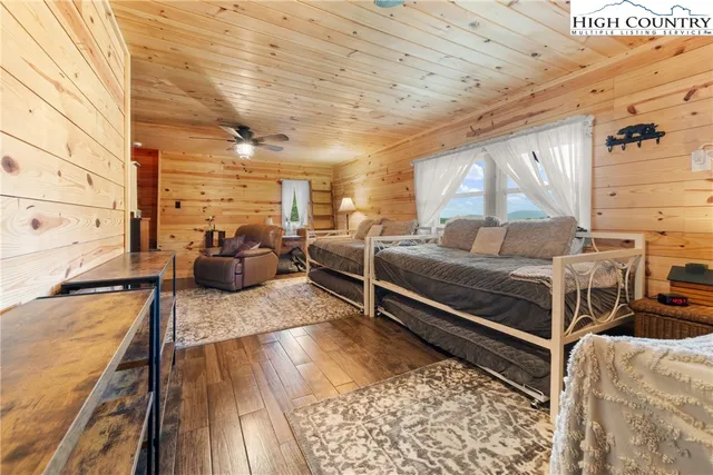 a bedroom with furniture and a wooden floor