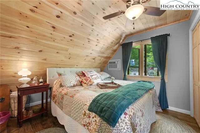 a bedroom with bed and a large window