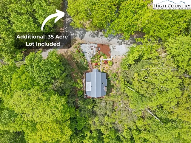 a sign of golf club on a wall under a tree