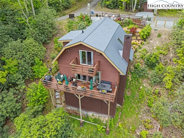 a aerial view of a house with swimming pool next to a yard