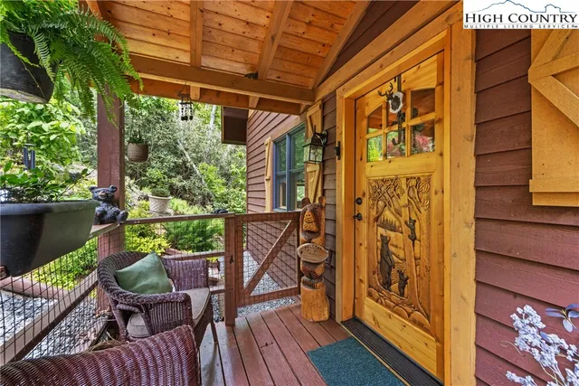 a view of a balcony with chairs and wooden floor