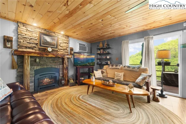 a living room with furniture a fireplace and a table