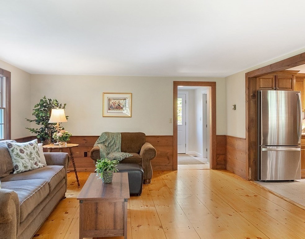 830 Liberty Square Road Boxborough, MA 01719 - Photo 12 of 40 a living room with furniture and a refrigerator
