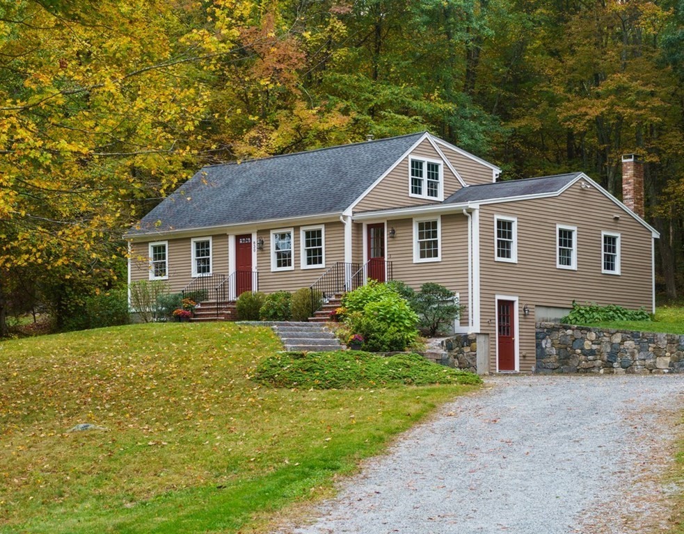 830 Liberty Square Road Boxborough, MA 01719 - Photo 2 of 40 a front view of a house with a yard and garage