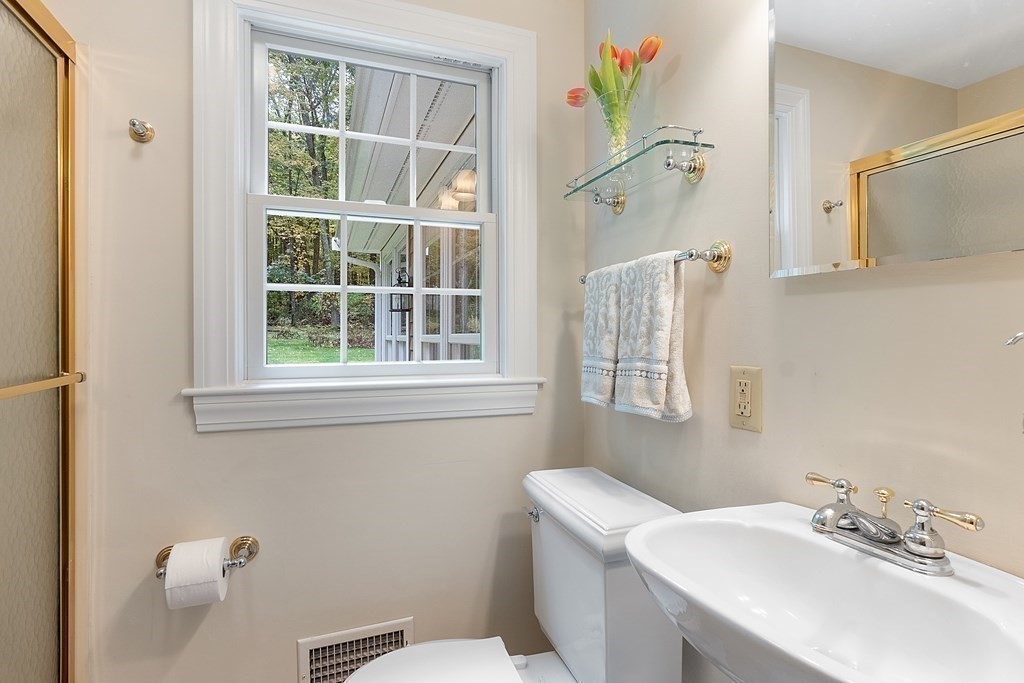 830 Liberty Square Road Boxborough, MA 01719 - Photo 23 of 40 a bathroom with a sink a toilet and a window