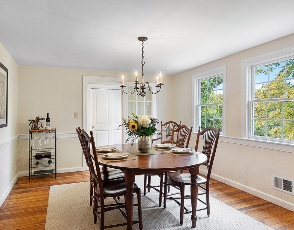 830 Liberty Square Road Boxborough, MA 01719 - Photo 3 of 40 a dining room with furniture a chandelier and wooden floor