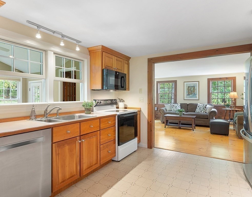 830 Liberty Square Road Boxborough, MA 01719 - Photo 6 of 40 a large living room with stainless steel appliances granite countertop a couch and a view of living room