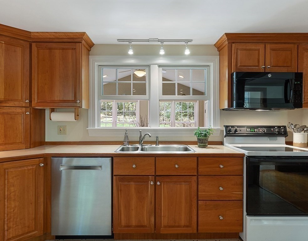 830 Liberty Square Road Boxborough, MA 01719 - Photo 7 of 40 a kitchen with a sink a stove and cabinets
