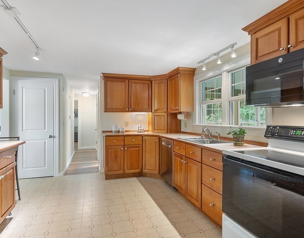 830 Liberty Square Road Boxborough, MA 01719 - Photo 8 of 40 a kitchen with a sink stove and cabinets