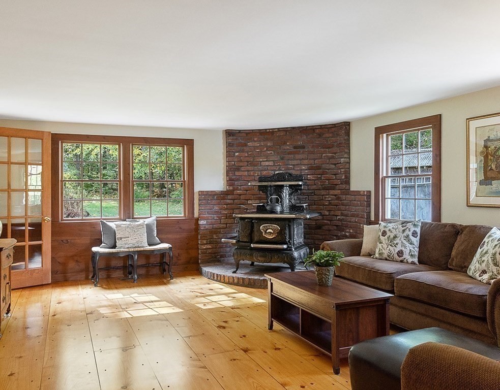 830 Liberty Square Road Boxborough, MA 01719 - Photo 10 of 40 a living room with furniture and a fireplace