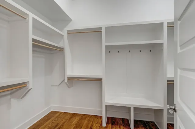 a view of empty room with wooden floor and fireplace