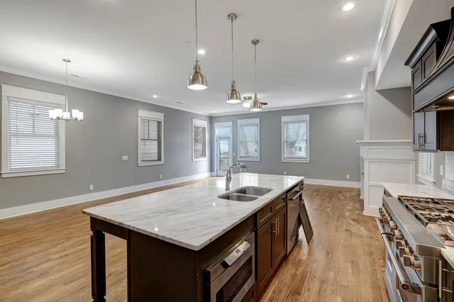 a bathroom with a granite countertop sink a toilet and shower