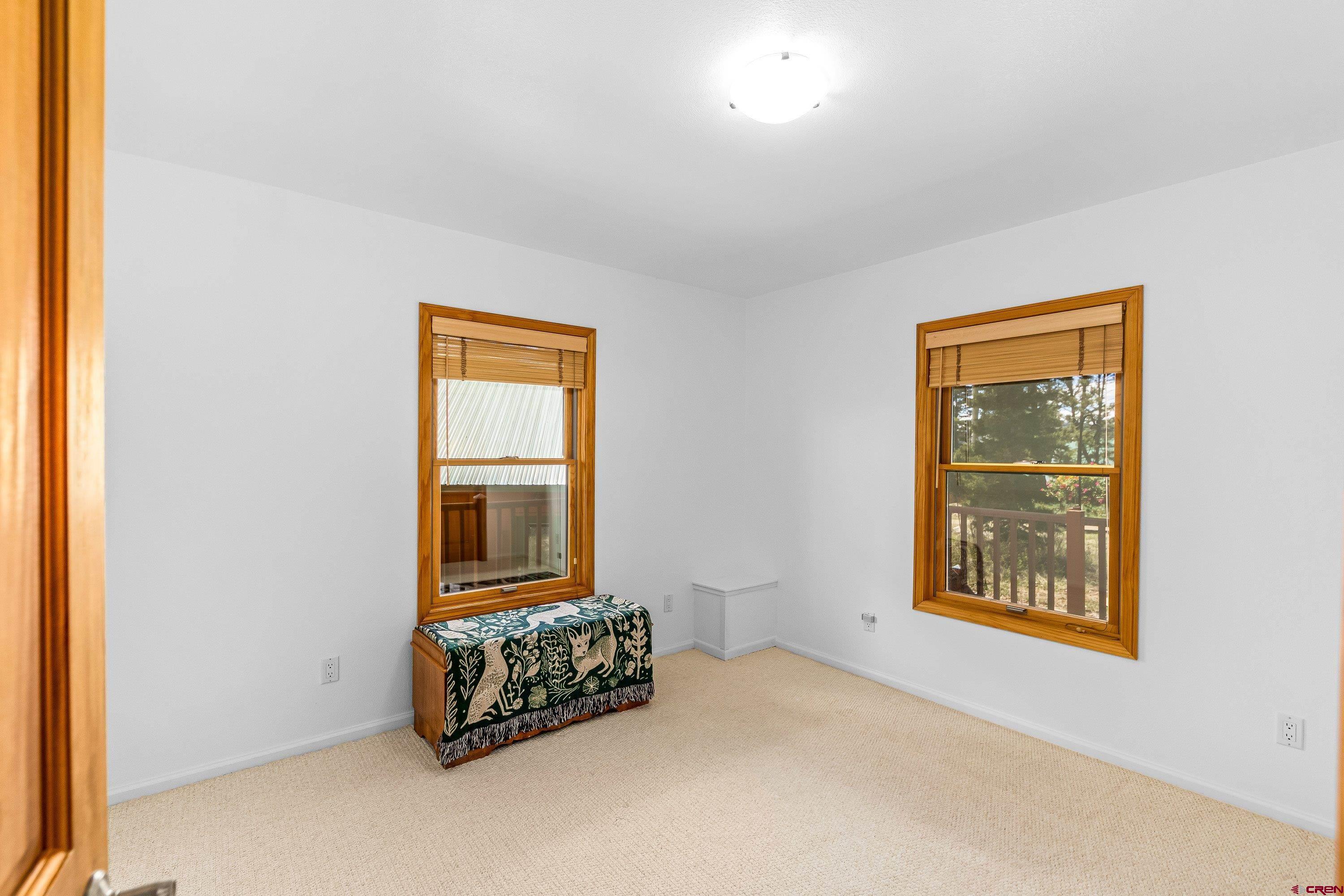 180 Ridge Road Cimarron, CO 81220 - Photo 17 of 42 a room with a bed and a window