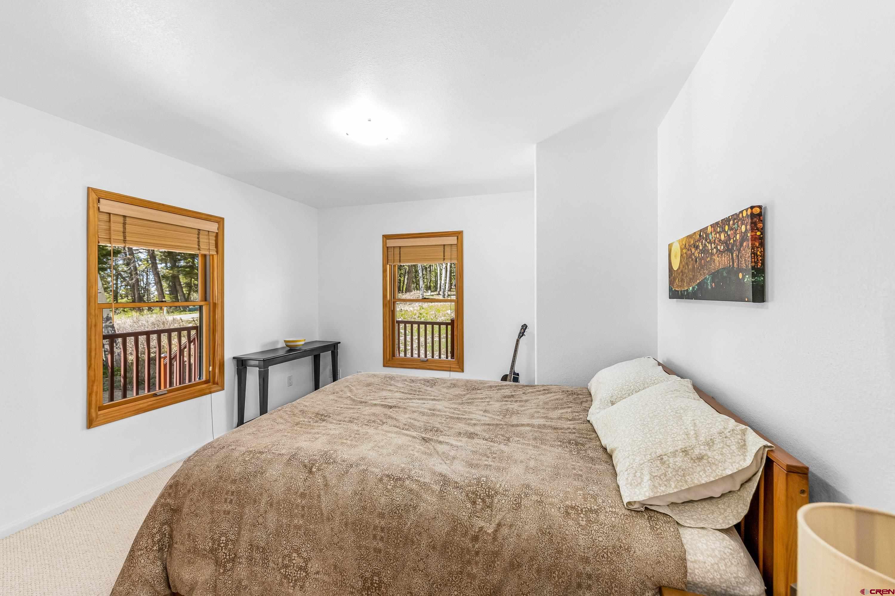 180 Ridge Road Cimarron, CO 81220 - Photo 19 of 42 a bedroom with a bed and a window