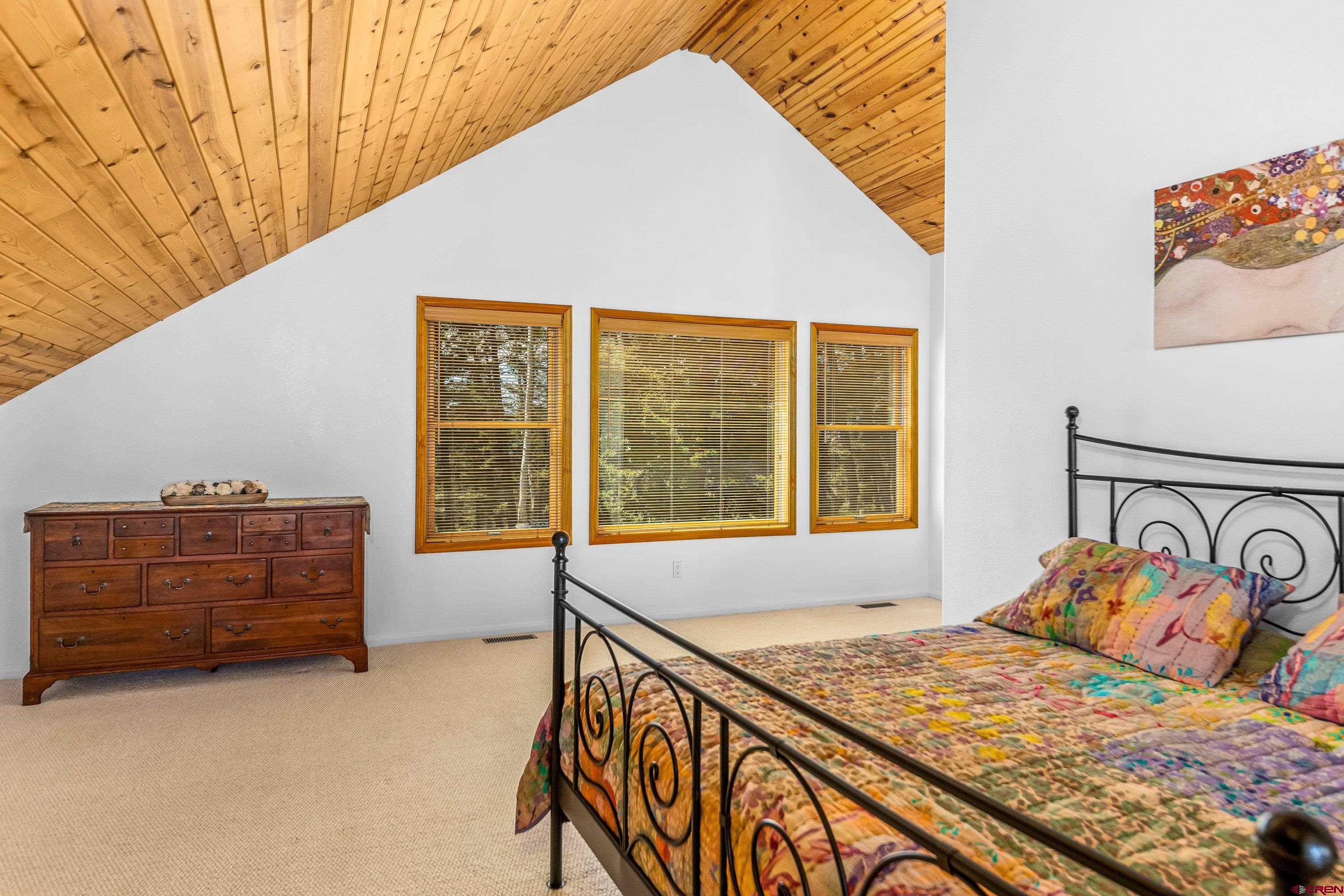 180 Ridge Road Cimarron, CO 81220 - Photo 24 of 42 a bedroom with a bed and window