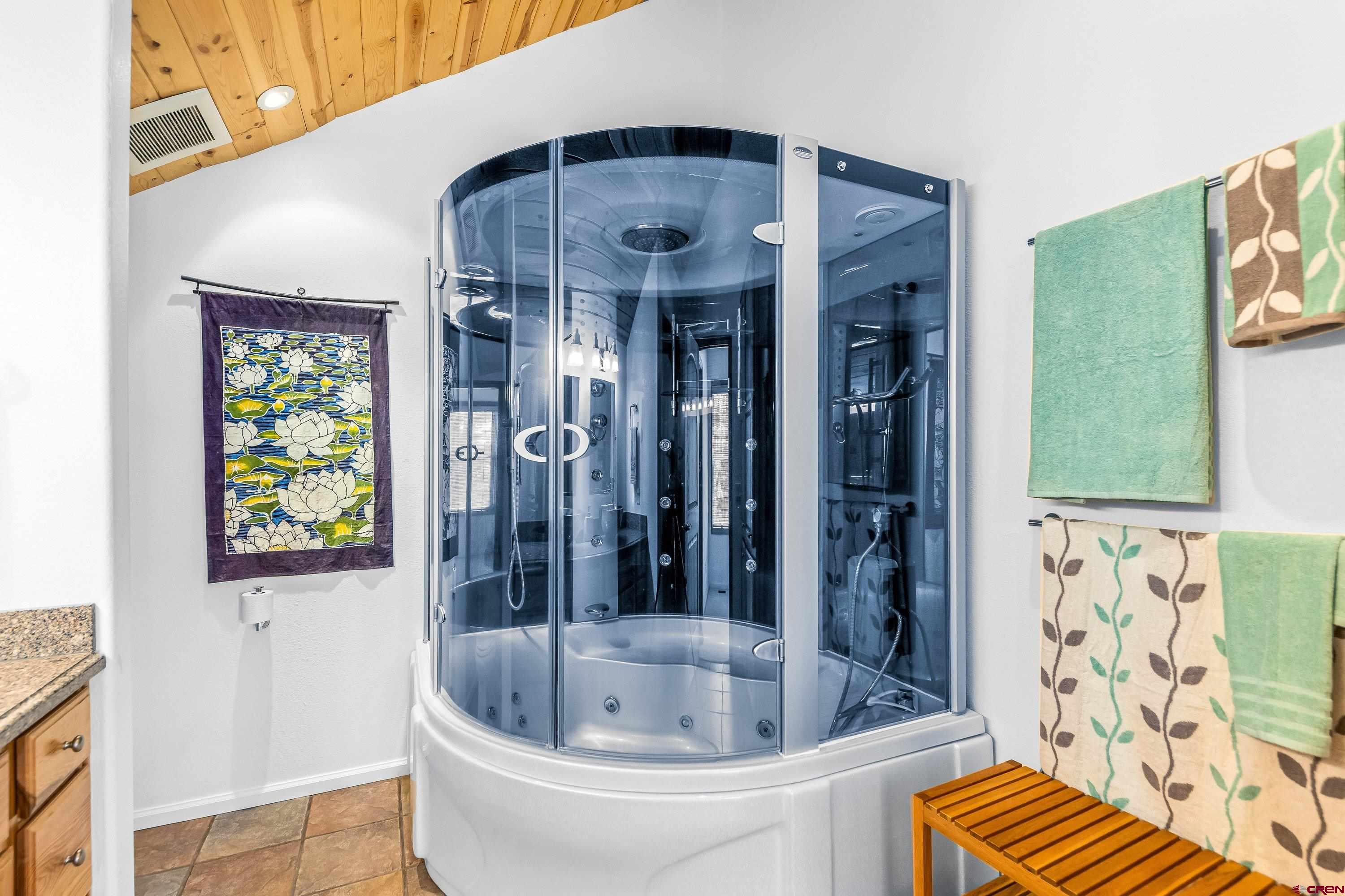 180 Ridge Road Cimarron, CO 81220 - Photo 26 of 42 a bathroom with a bathtub and a shower