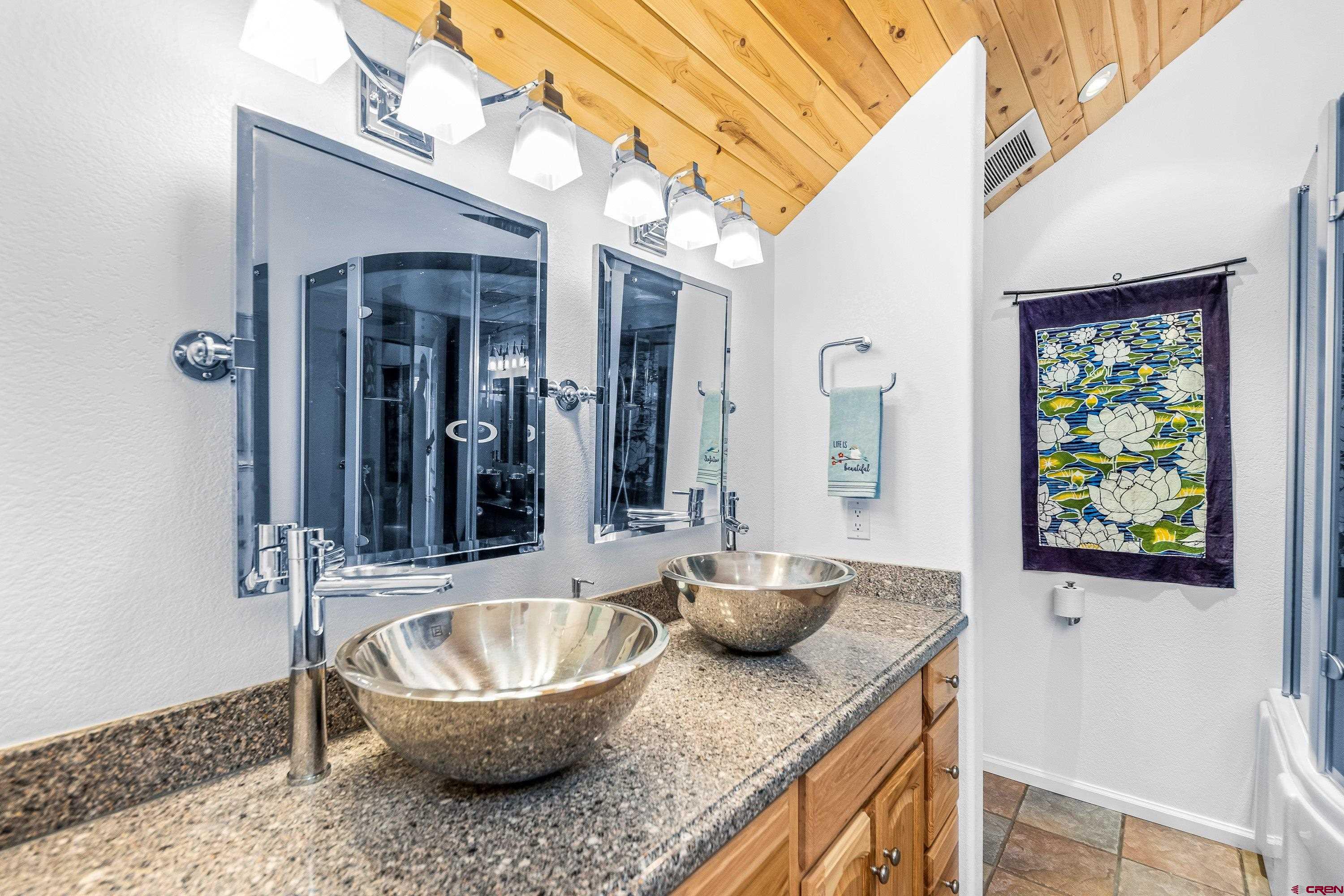 180 Ridge Road Cimarron, CO 81220 - Photo 27 of 42 a bathroom with a granite countertop sink and a mirror