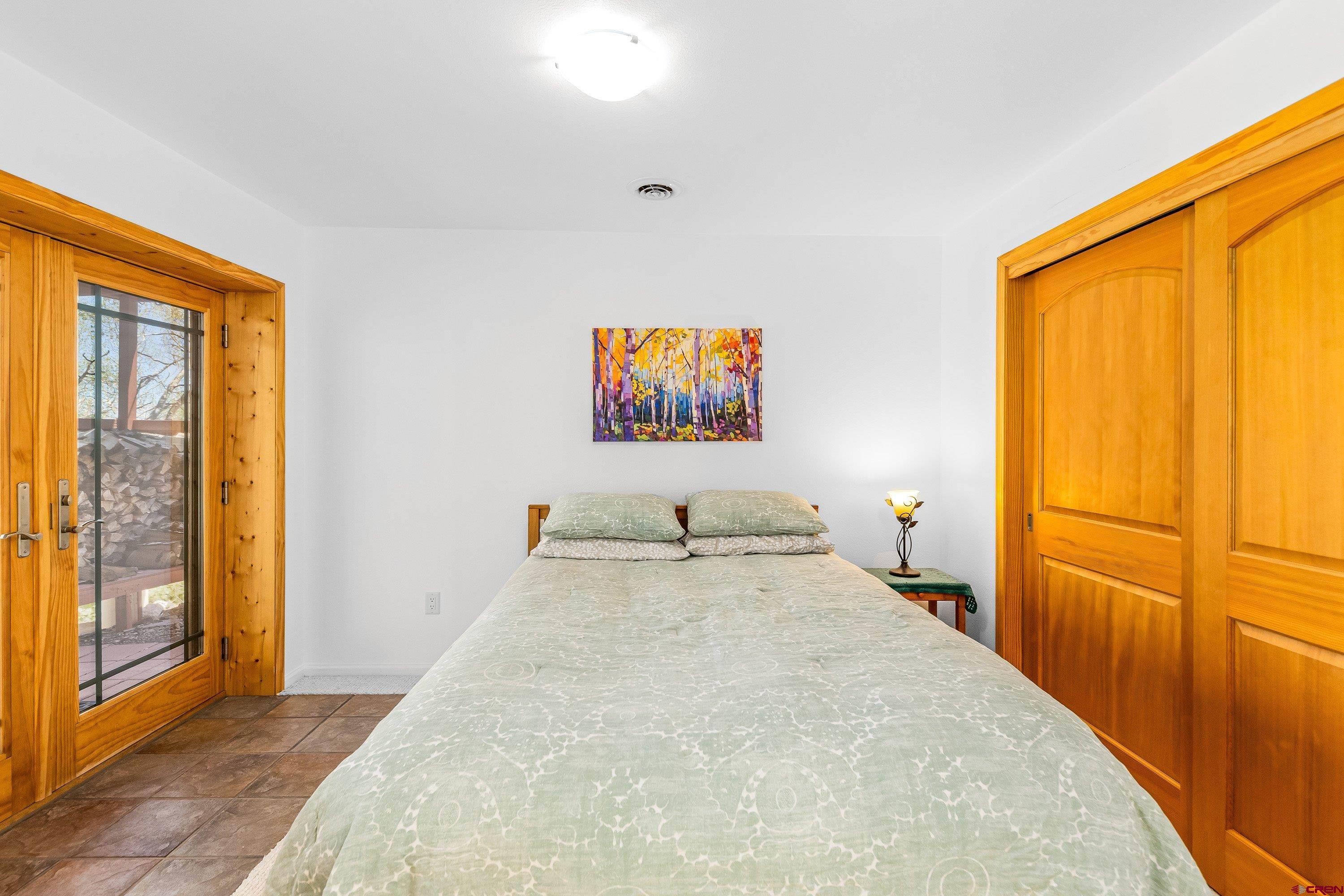 180 Ridge Road Cimarron, CO 81220 - Photo 33 of 42 a bedroom with a bed and a large window