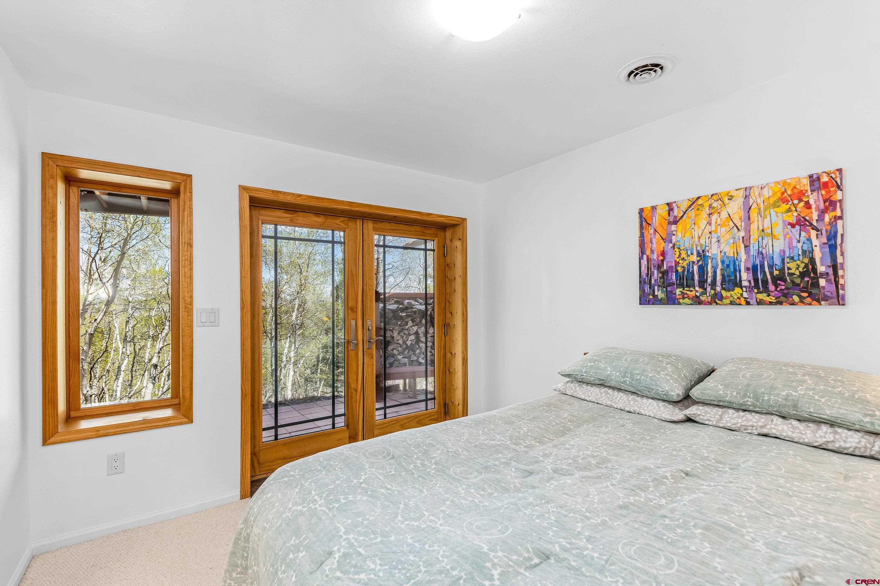 180 Ridge Road Cimarron, CO 81220 - Photo 34 of 42 a bedroom with a large bed and a window