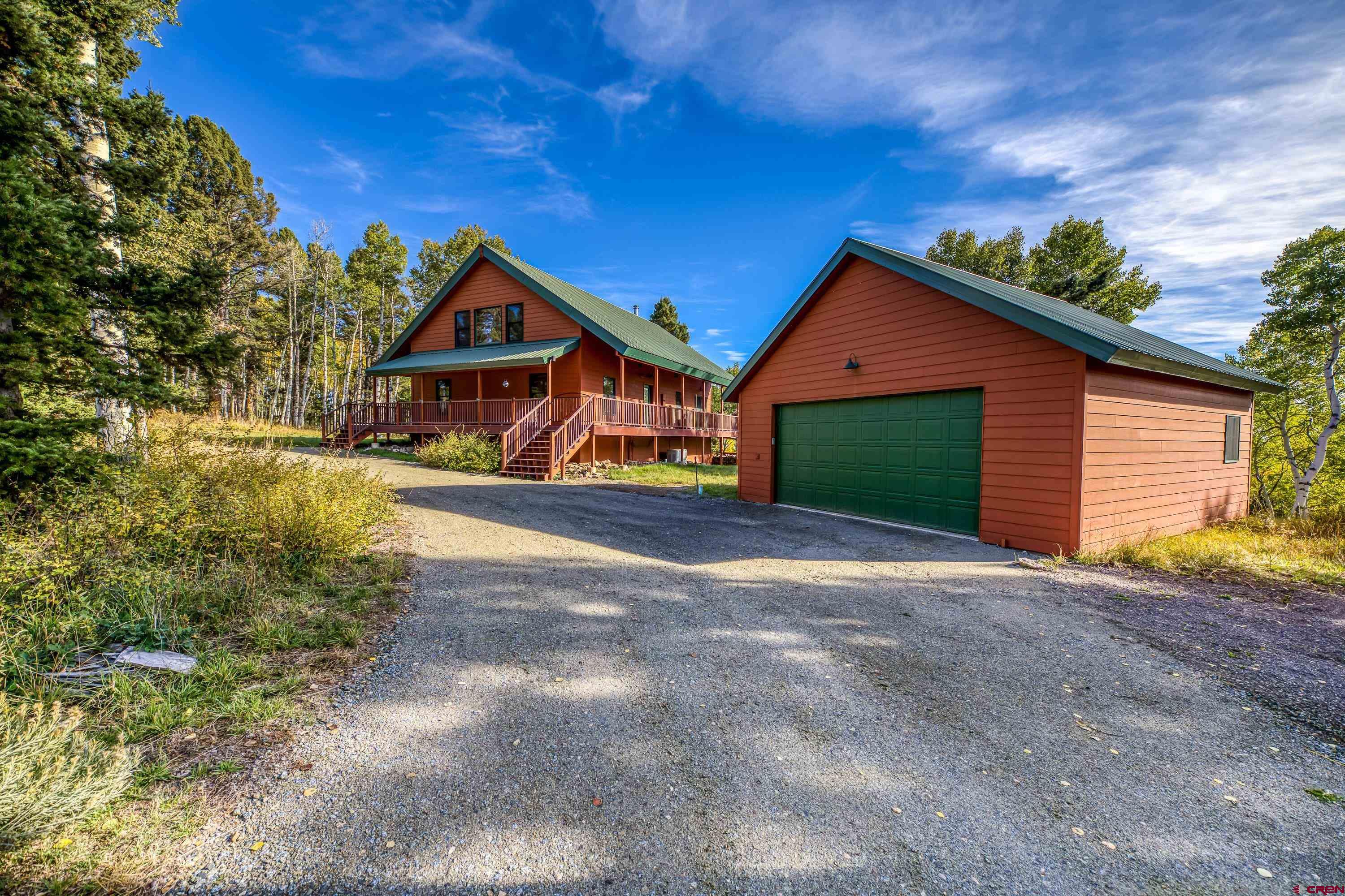 180 Ridge Road Cimarron, CO 81220 - Photo 37 of 42 a view of a house with a yard and large tree