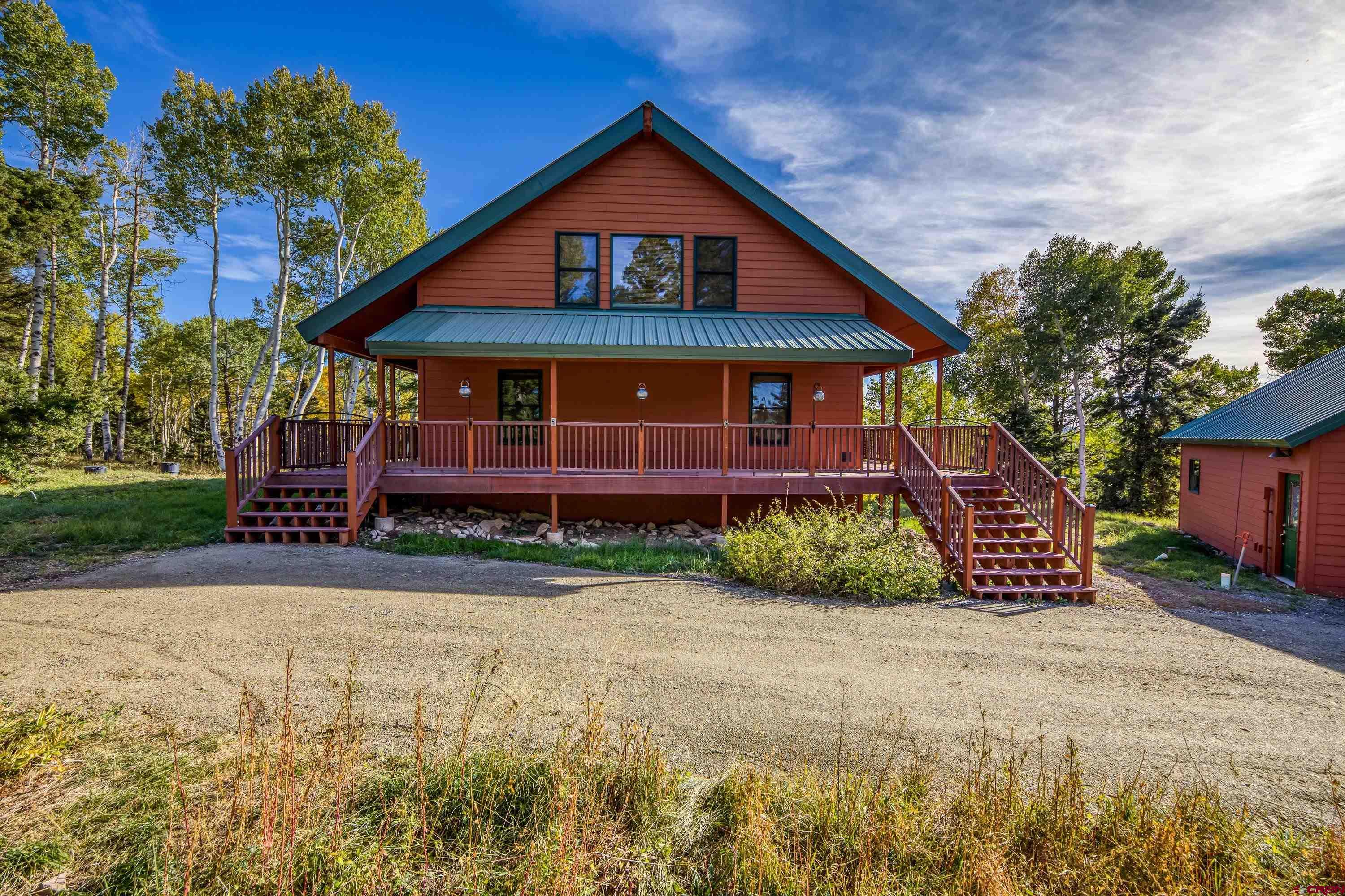 180 Ridge Road Cimarron, CO 81220 - Photo 38 of 42 a front view of a house with a yard