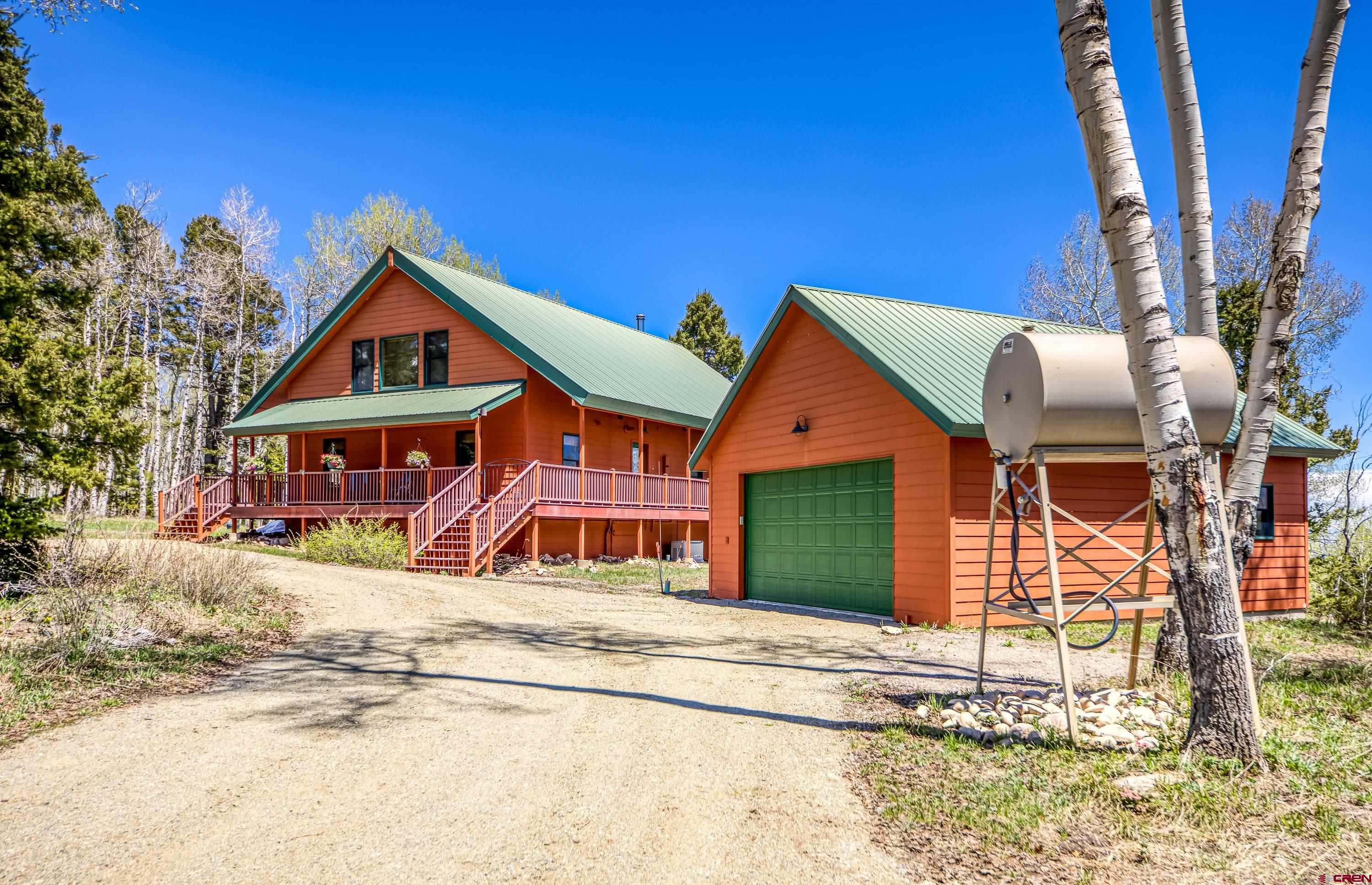180 Ridge Road Cimarron, CO 81220 - Photo 8 of 42 a front view of a house with a porch