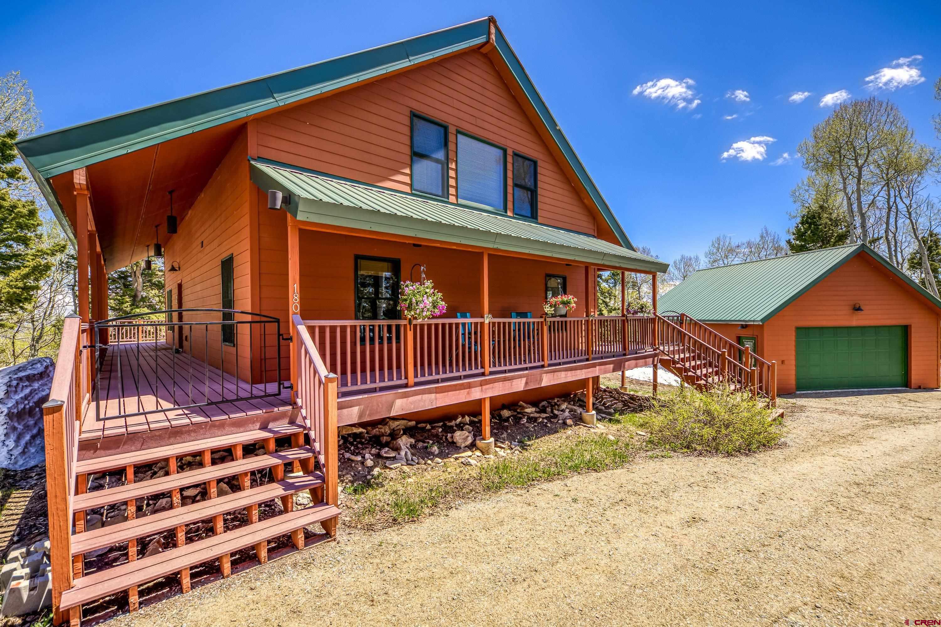 180 Ridge Road Cimarron, CO 81220 - Photo 9 of 42 a front view of a house with a yard