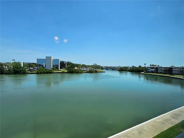 a view of a lake with houses in the back