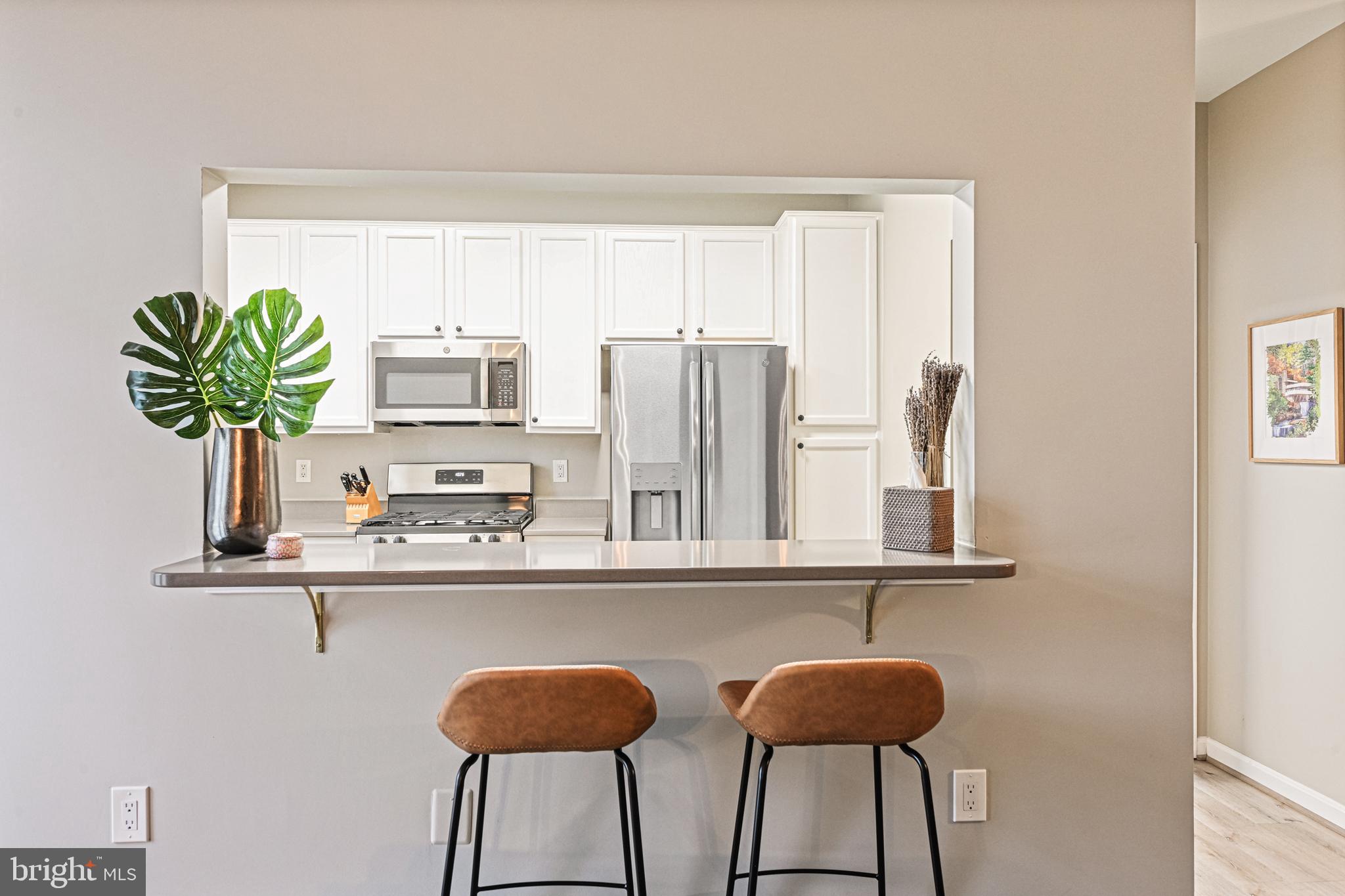 11401 Gate Hill Place, Unit 68 Reston, VA 20194 - Photo 11 of 26 Kitchen pass through features space for barstools